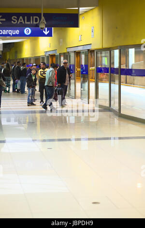 LIMA, PERU - JULY 21, 2013: Unidentified people waiting for the Metropolitano bus at the central bus station on July 21, 2013 in Lima, Peru.  The Metropolitano is a Bus rapid transit sytem operating since 2010 in Lima running from North to South. Stock Photo