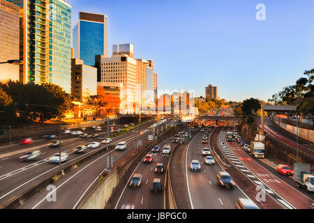 Morning city traffic on Warringan freeway in Sydney between North Sydney high-rises - daily communters. Stock Photo