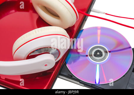Portable computer with DVD compact disc and red white headphones isolated Stock Photo