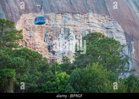 Stone Mountain Park's Summit Skyride cable car climbs to the top of Stone Mountain with a view of the Confederate Memorial Carving near Atlanta, GA. Stock Photo
