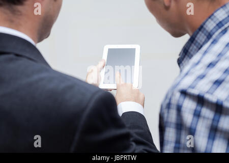 Detail of two businessmen using digital tablet. Stock Photo
