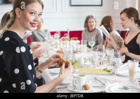 Group of women celebrating in restaurant Stock Photo