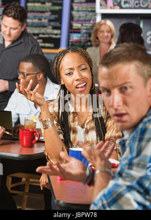 Mixed Black and white couple arguing in a cafe Stock Photo