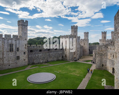CAERNARFON, WALES - 29 SEPTEMBER 2013: View on the inner courtyard at Caernarfon Castle, well-known for its polygonal towers.   In 1969 Prince Charles was invested here as Prince of Wales by HM Queen Elizabeth II. Stock Photo