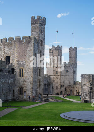 CAERNARFON, WALES - 29 SEPTEMBER 2013: Caernarfon Castle, well-known for its polygonal towers, dates from the 13th century.  In 1969 Prince Charles was invested here as Prince of Wales by HM Queen Elizabeth II. Stock Photo