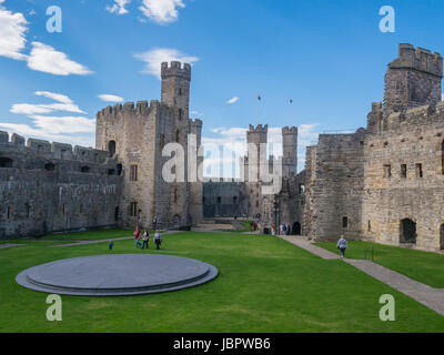 CAERNARFON, WALES - 29 SEPTEMBER 2013: Inner courtyard at Caernarfon Castle, well-known for its polygonal towers.   In 1969 Prince Charles was invested here as Prince of Wales by HM Queen Elizabeth II. Stock Photo