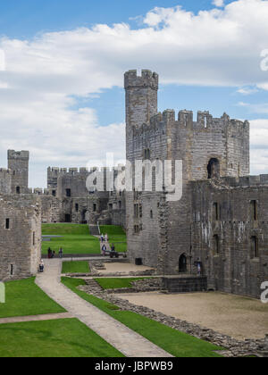 CAERNARFON, WALES - 29 SEPTEMBER 2013: Caernarfon Castle, well-known for its polygonal towers, dates from the 13th century.  In 1969 Prince Charles was invested here as Prince of Wales by HM Queen Elizabeth II. Stock Photo