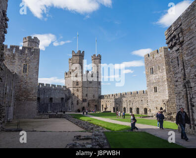 CAERNARFON, WALES - 29 SEPTEMBER 2013: Inner courtyard at Caernarfon Castle, well-known for its polygonal towers.   In 1969 Prince Charles was invested here as Prince of Wales by HM Queen Elizabeth II. Stock Photo