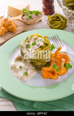 ,,tagliatelle con Spinaci,, with chanterelles Stock Photo