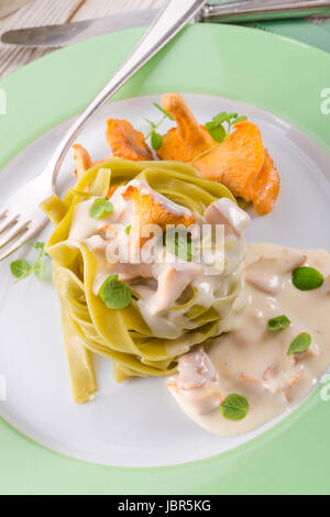 ,,tagliatelle con Spinaci,, with chanterelles Stock Photo