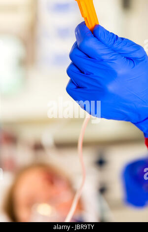 Ambulance Emergency doctor or paramedic medicate accident victim with infusion Stock Photo