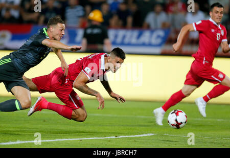 Belgrade. 11th June, 2017. Serbia's Aleksandar Mitrovic (C) vies with Wales's James Chester (L) during group D 2018 World Cup qualifying football match between Serbia and Wales in Belgrade, Serbia on June 11, 2017. The match ended with a draw 1-1. Credit: Predrag Milosavljevic/Xinhua/Alamy Live News Stock Photo