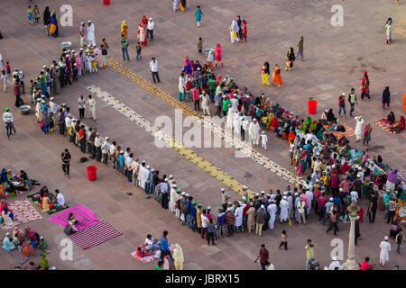 NEW DELHI, INDIA. JUNE 8,2017:Top view of the Jama Masjid courtyard as seen from one of it's Minarets. People arrive to break their day long fast. Stock Photo