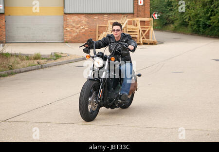 Riding a Harley Davidson 48 Sportster Motorcycle Stock Photo