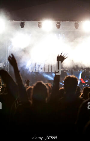 Cheering crowd in front of bright colorful stage lights Stock Photo - Alamy
