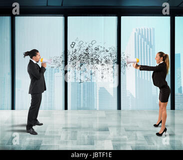 Two collegues screaming each other with megaphone in office Stock Photo