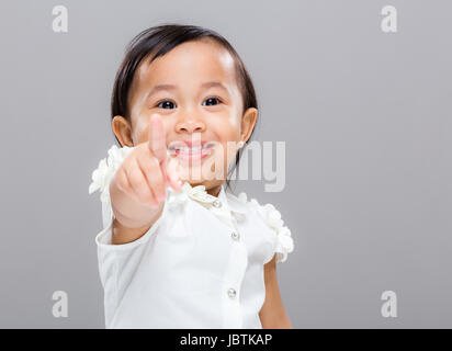 Baby girl point to front Stock Photo