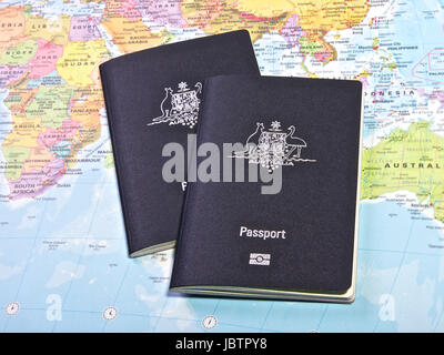 Australian Passport With the World map in the Background Stock Photo