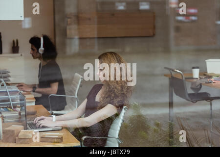 Female executive working on laptop at desk in office Stock Photo