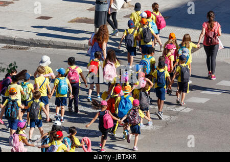 School children crossing a traffic light Stock Photo