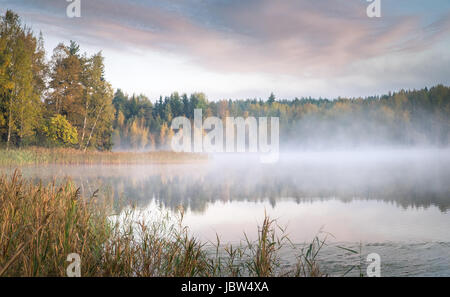 Scenic landscape with lake and fall colors at morning light Stock Photo