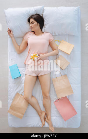 Attractive young woman being surrounded by shopping bags Stock Photo
