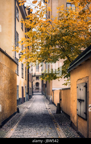 STOCKHOLM, SWEDEN - October 14, 2016: View from narrow and idyllic street with colorful buildings in Gamla Stan. The Old Town in Stockholm, Sweden. Cl Stock Photo