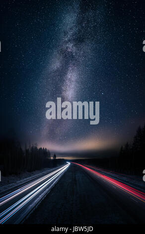 Scenic night landscape with milky way and highway Stock Photo
