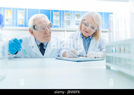 portrait of senior scientists working on experiment in lab Stock Photo