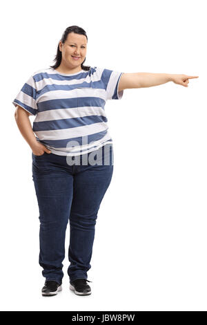 Full length portrait of a woman pointing right and looking at the camera isolated on white background Stock Photo