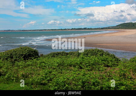 A view across the mouth of the River Ogmore looking out towards the town of Porthcawl with sandy beaches and blue waters. Stock Photo