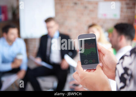 Reading diagrams on phone screen Stock Photo