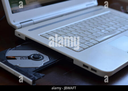 Close up  of a White Laptop with CD-ROM board open Stock Photo
