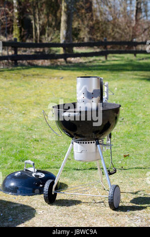 one kettle barbeque with a lighter on the top ready to grill Stock Photo