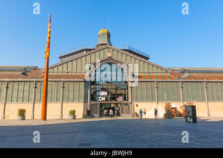 BARCELONA, SPAIN - JUNE 1, 2017: The facade of Born market, and flag of Catalonia. It is an example of iron architecture, a movement within the modern Stock Photo