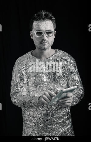 Portrait of spaceman using digital tablet. Stock Photo