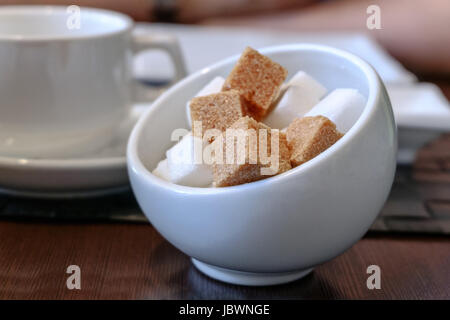 Shugar in bowl on wooden table cloaeup Stock Photo