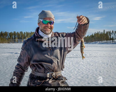 Ice fishing, Kangos, Lapland, Sweden Stock Photo
