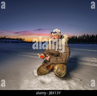 Ice Fishing, Kangos, Lapland, Sweden Stock Photo