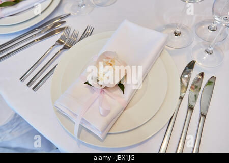 Spring table settings with fresh flower, napkin and silverware. Holidays background. Selective Focus Stock Photo