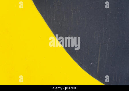 Abstract detail of wall with fragment of graffiti, old chipped paint, scratch, grunge texture. Aerosol design, black-yellow colors. Modern background, banner design Stock Photo