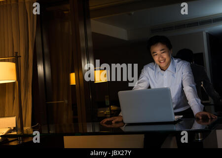 Asian man work at night in the office. Stock Photo