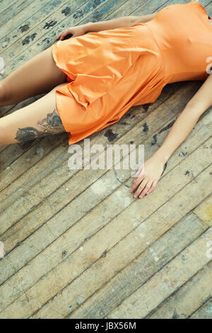 Dead woman's body laying down on the floor Stock Photo