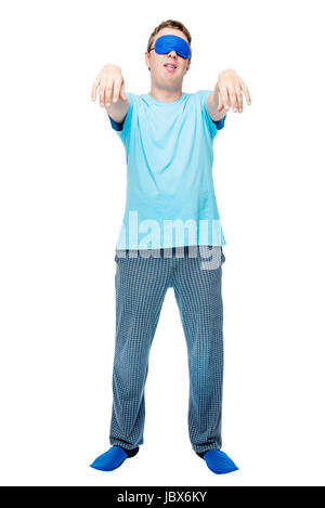 Portrait of a sleepy man in pajamas on a white background suffers from sleepwalking Stock Photo