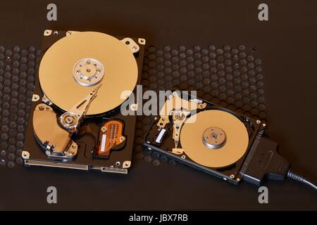 A 3.5 inch desktop and a 2.5 inch laptop hard disk side by side Stock Photo