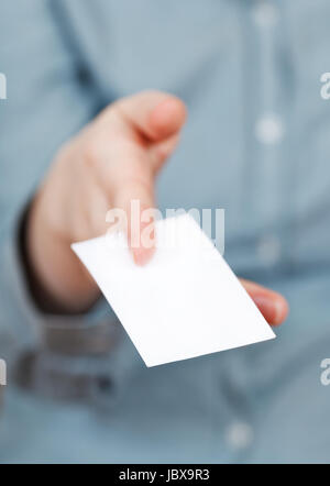 blank business card in between female fingers close up Stock Photo