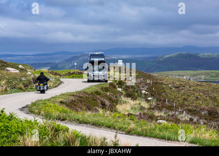 Motorhome and motorbike at passing place on winding single track road in the Scottish Highlands, Scotland, UK Stock Photo