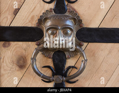 retro vintage wooden gates with strips from metal and vintage hand knocker in shape of lion head Stock Photo