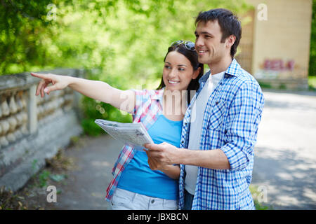 Portrait of pretty female showing her husband sights of the city Stock Photo