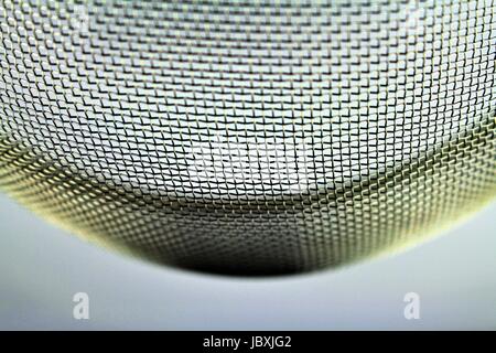 An image of a metal sieve - macro - focus in the center Stock Photo